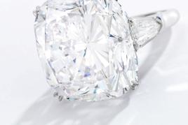 Lot 57 An Impressive Diamond Ring, Harry Winston Set with a cushion-cut diamond weighing 51.52 carats, flanked by two shield-shaped diamonds Estimate $3.5/4.5 million Sold for $3,975,000