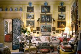 Mario Buatta’s Manhattan apartment photographed for Architectural Digest in 1997. The living room is glazed in three shades of lime green and creamy white, with a faux-sisal painted floor. Over the sofa hangs Mario’s collection of dog paintings. Mario often joked, “These paintings are my ancestors. Seriously, I love dogs. I don’t have a dog because I have such a busy schedule, but I love viewing them on the wall.” Photo: Scott Frances for Architectural Digest/Otto Archive