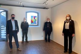 Foto: Präsentation des Glasbildes "Big City" im Museum: (v. l. n. r.) Carlo Aretz (Geschäftsführer des Museums), Karl-Heinz Schumacher (Künstler), Heinrich Oidtmann (Betriebsinhaber Dr. H. Oidtmann GmbH in Linnich) , Luzia Schlösser (Museumsleiterin)