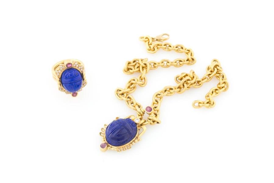 SCHMUCK-SET MIT LAPISLAZULI UND EDELSTEINBESATZ, Deutsch, Straubing, Schmuck und Juwelenatelier Hilz, 20./21. Jh., Gelbgold. Ring und Ankerkette mit insg. zwei Lapislazulis, vier Rubinen sowie 25 Brillanten. Limit 2.800,- €