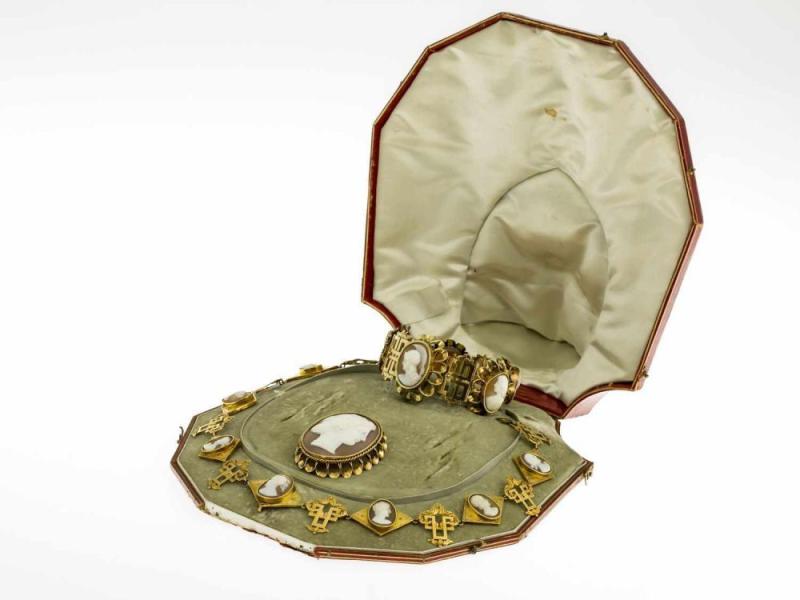 Feine Kameen-Parure Collier, Armband und Brosche. Gelbgold 585 (geprüft). Ausgefasst mit Muschelkameen mit versch. Portraits im Profil. Um 1830/1840. L. 19 bzw. 46 cm. Zus. ca. 92 g. Orig.-Etui. Aufrufpreis:	2.000 EUR