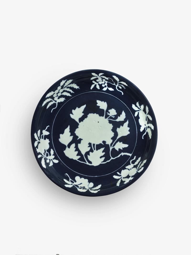 Lot 6 Property of a Gentleman An Exceptionally Rare and Large Fine Blue and White Reserve-Decorated ‘Peony’ Dish Xuande Mark and Period Diameter 15 1/4 in., 38.6 cm Estimate $1/1.5 million Sold for $ 2,172,500