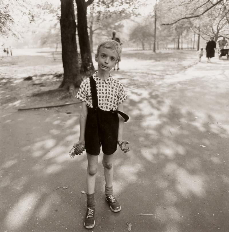 Diane Arbus 'Child with a Toy Hand Grenade in Central Park, N. Y. C.' signed, titled, dated, and editioned '72/75' by Doon Arbus, the photographer's daughter, in ink and with the 'A Diane Arbus Photograph' and reproduction rights stamp on the reverse, framed, exhibition labels on the reverse, 1962, printed posthumously by Neil Selkirk 14 3/4  by 15 in. (27.5 by 38 cm.) Estimate $70/100,000