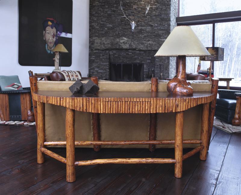 Lot 7 Thomas Molesworth A Rare Sofa Back Console Table from Indian Head Ranch, Wyoming with single drawer fir, original brown leather, half-pole trim 301/8 x753/4 x183/4 in.(76.5x192.4x47.6cm) circa 1937 Estimate $25/35,000