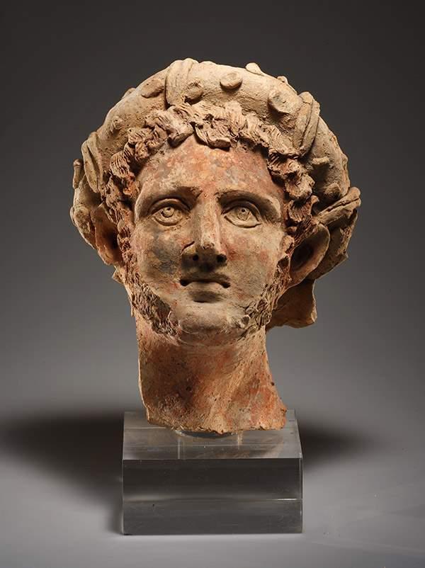 Cahn A. G. A Head of a Man with Wreath  H. 29.7 cm. Orange clay with inclusions Etruscan late 3rd-2nd cent. B.C.