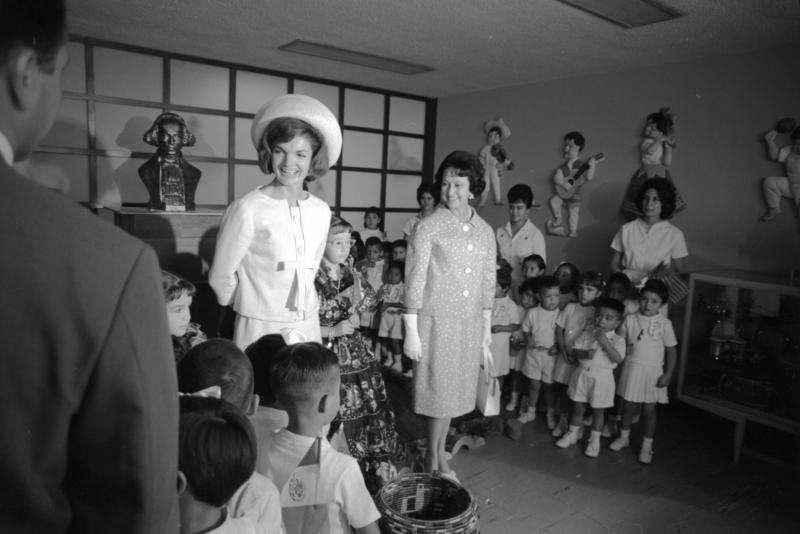 Zweiteiliges Damenkostüm, Oleg Cassini, 1962, getragen von First Lady Jacqueline Kennedy bei einem Besuch in einem mexikanischen Kinderschutzzentrum © @Cecil Stoughton, White House / John F. Kennedy Presidential Library and Museum