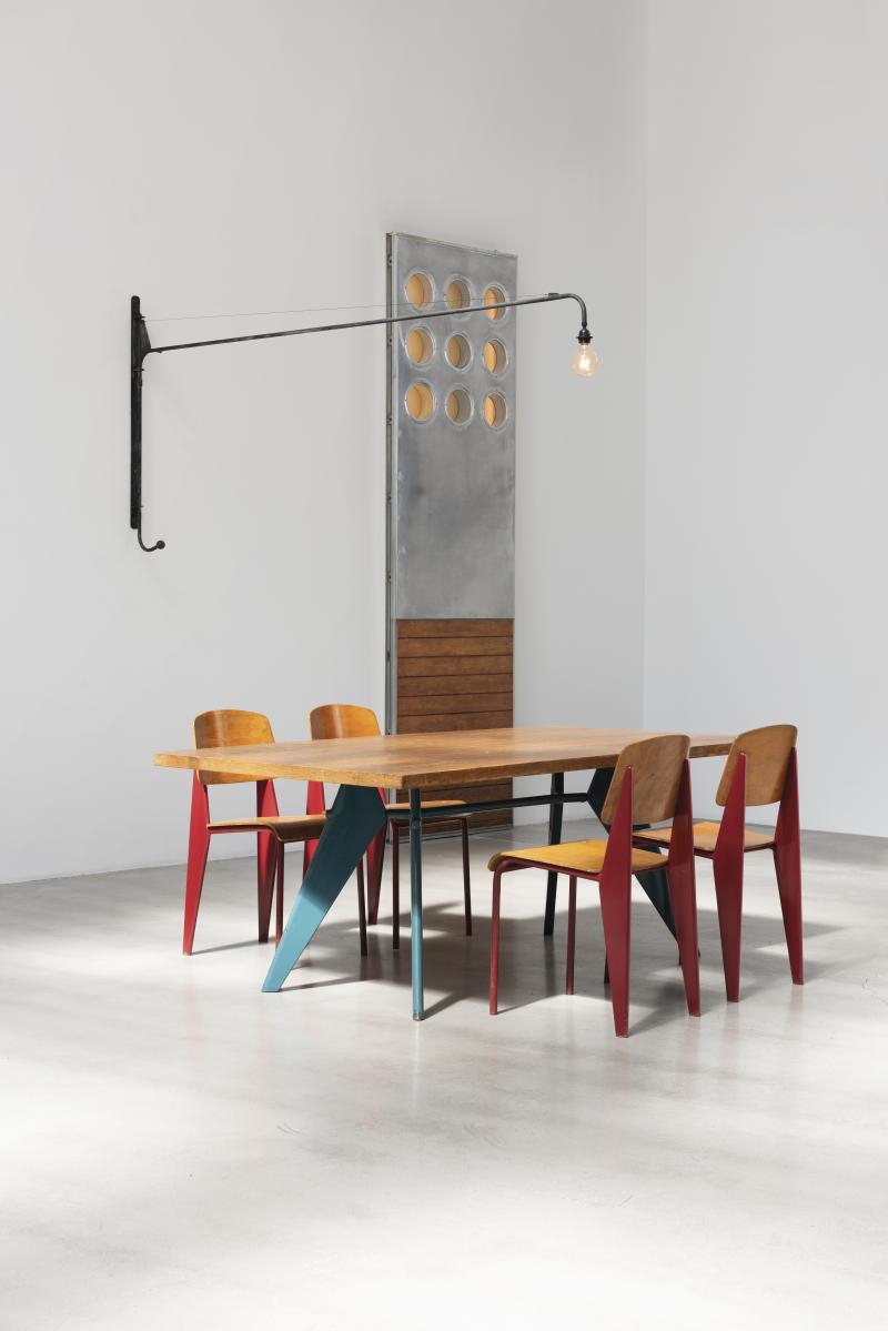 Galerie Patrick Seguin presents 'S.A.M. no. 506 table' (ca. 1951), 'Metropole no. 305 chairs' (ca. 1950), 'Panel with portholes' (1950) and 'Swing-jib lamp no. 602' (1952) by Jean Prouve. Image courtesy of Galerie Patrick Seguin.