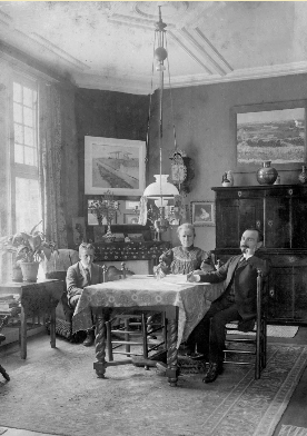 Jo van Gogh Bonger (centre) in her living room, surrounded by paintings by Van Gogh. On the left of the picture is her son Vincent.